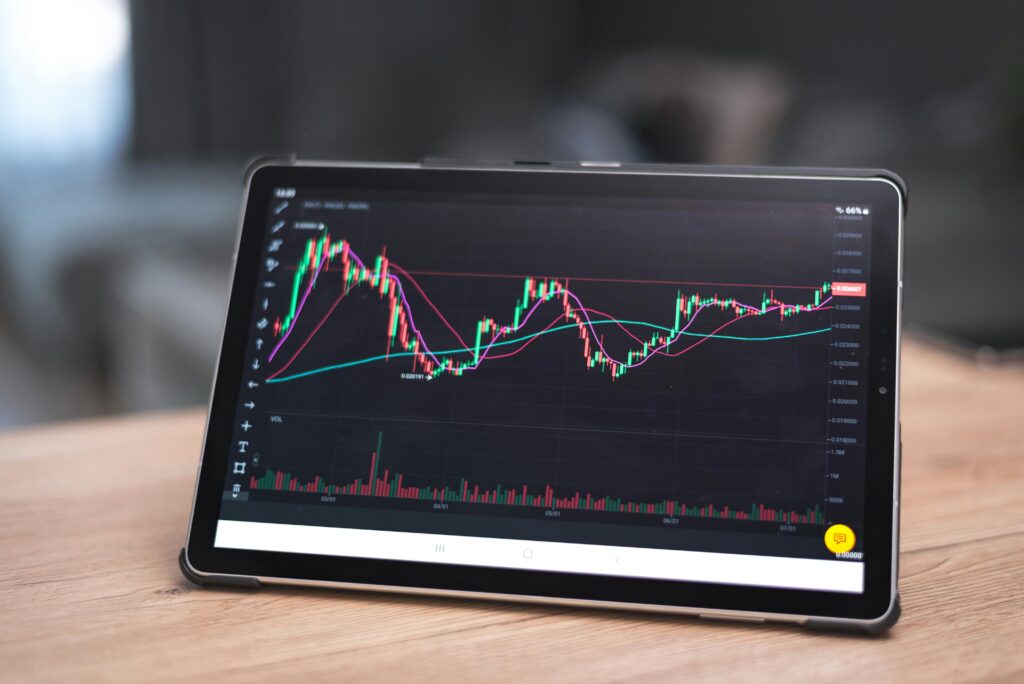 Close-up of a tablet showing financial graphs and trends. Ideal for finance and technology themes.